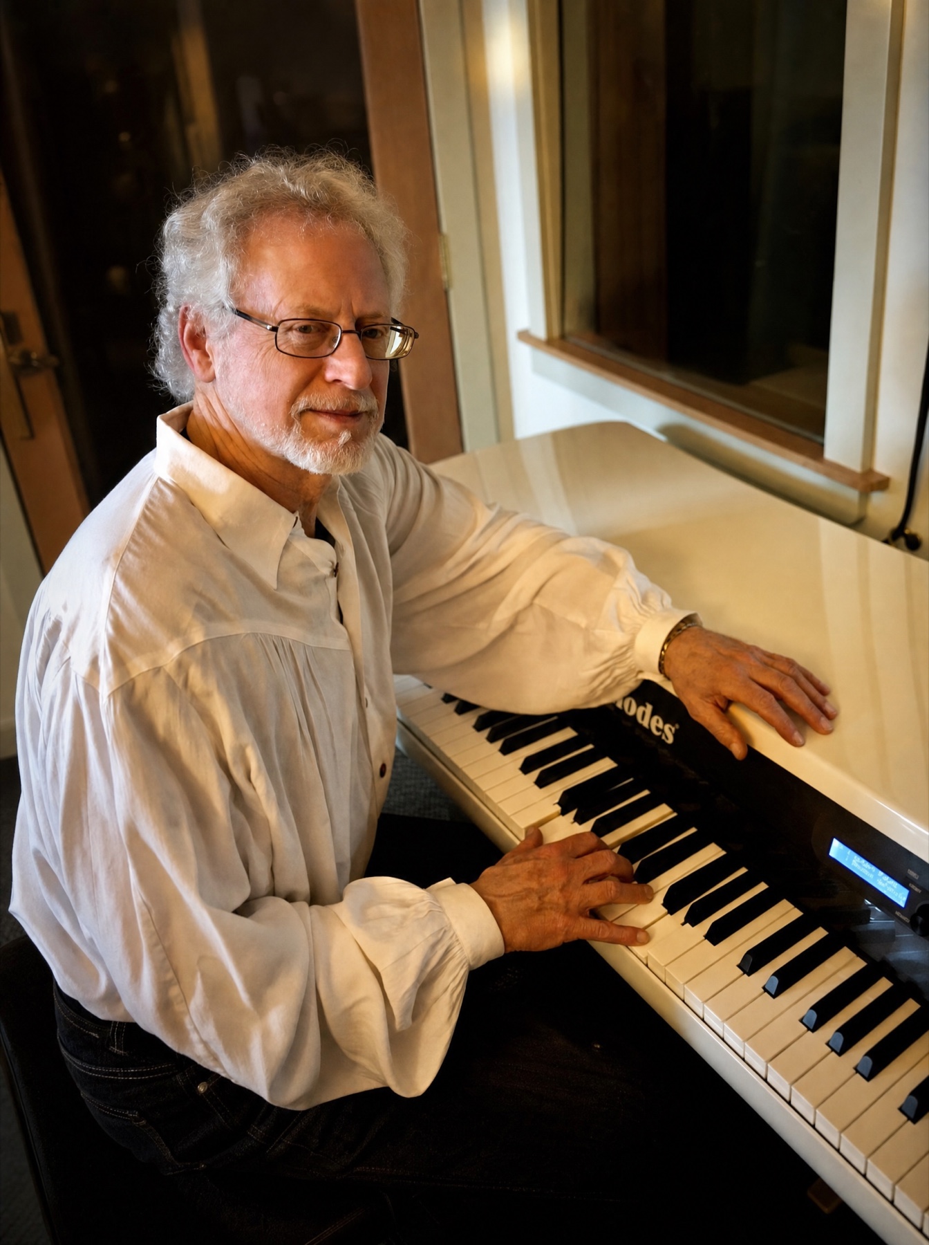 Steven Halpern seated at the Fender Rhodes in his studio